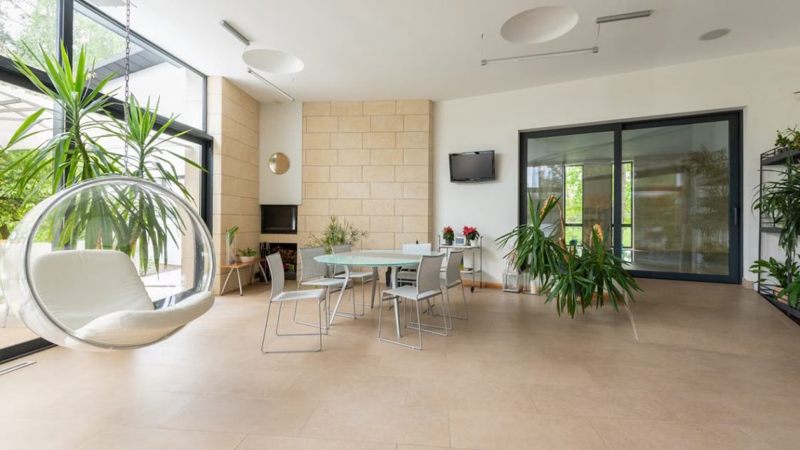 Modern large apartment with contemporary interior and table with chairs in bright daylight