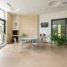 Modern large apartment with contemporary interior and table with chairs in bright daylight