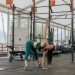 Caucasian woman stretching in a modern gym environment, promoting fitness and exercise.